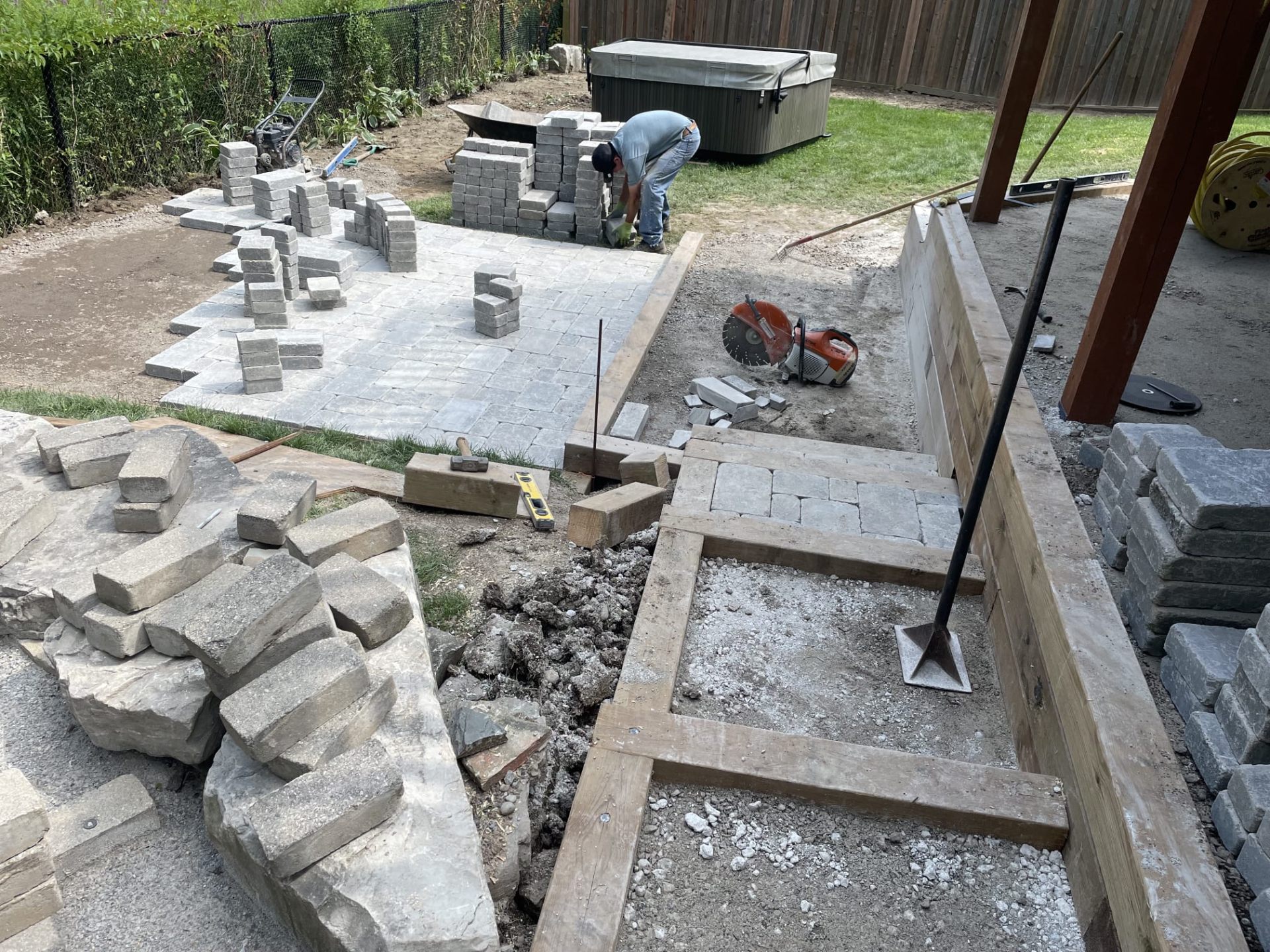 Backyard interlocking patio and timber retaining wall renovation in progress